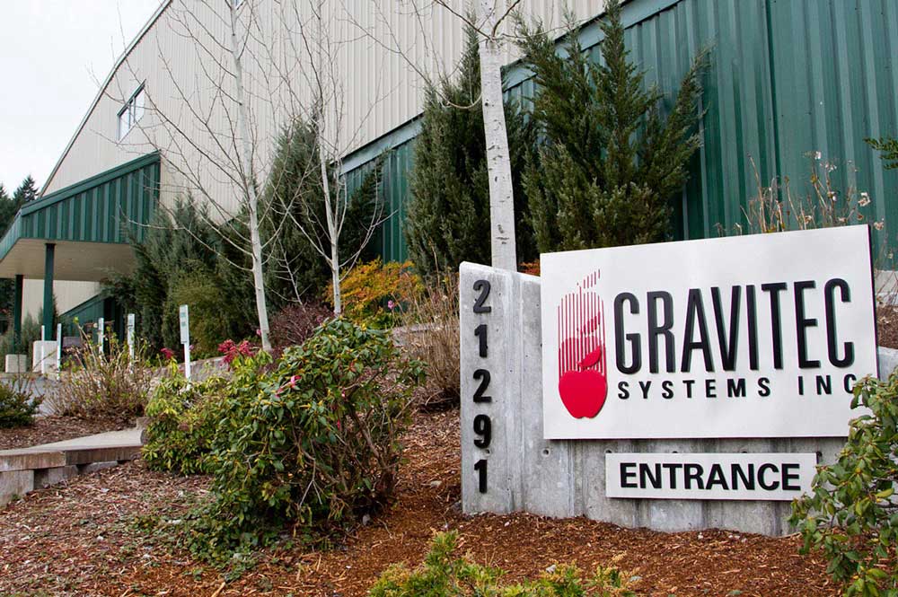 Gravitec metal sign in front of the building.